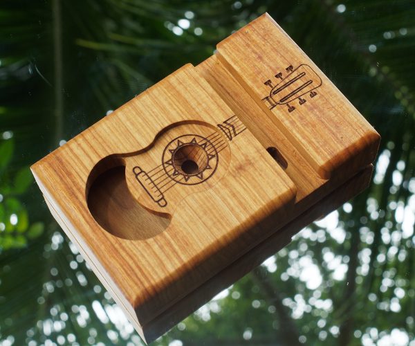 Canarywood speaker with a carved guitar